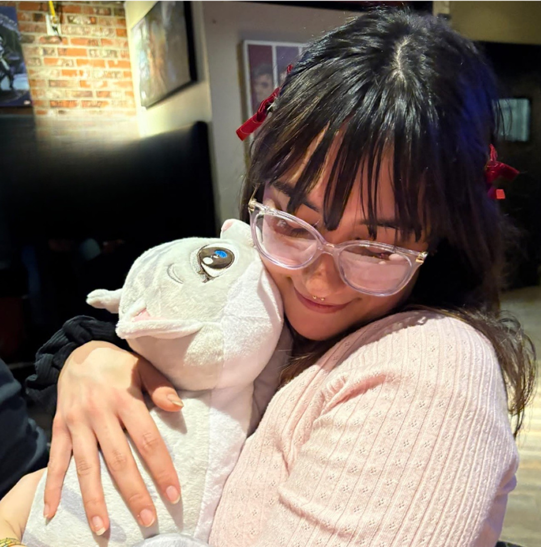 Woman hugging plush cat toy